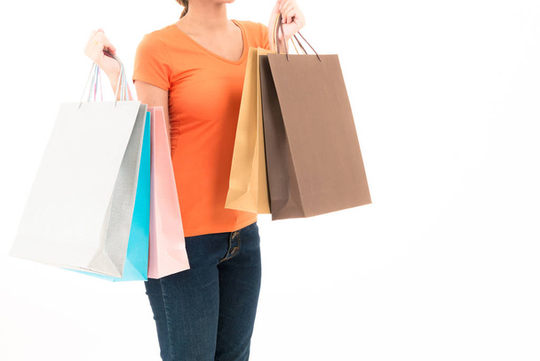 Young confident attractive Asian orange shirt woman with shoppin - 写真・画像