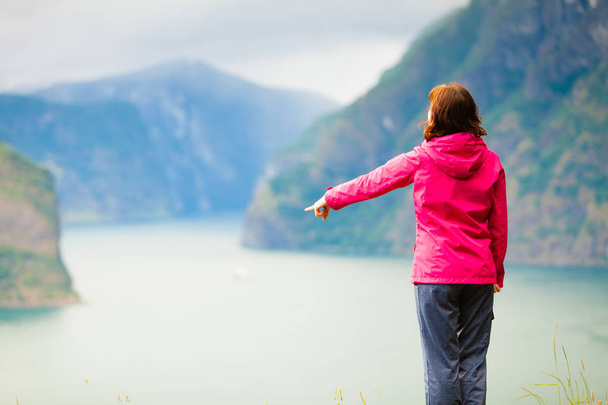 Tourist woman enjoying fjord view in Norway - Фото, изображение