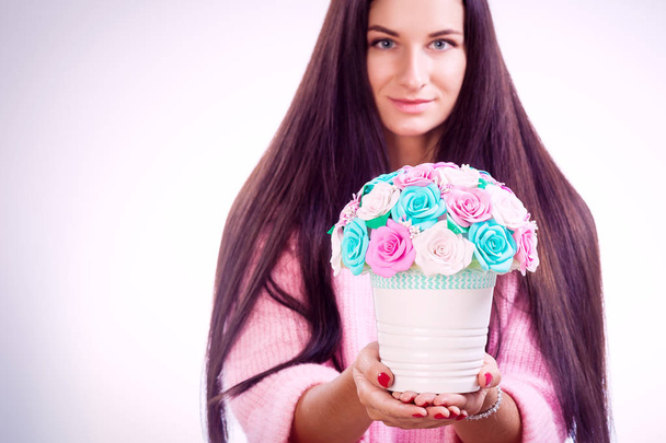 woman holds artificial flowers roses from foam  - Photo, Image