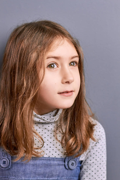 Portrait of thinking little girl indoor. - Valokuva, kuva