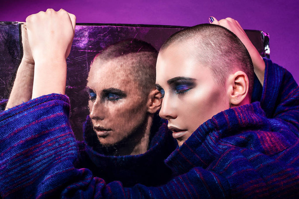 Young fashion model posing in studio. Bald. Bright make up. - Photo, image