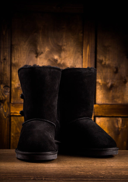 Srudio shot of pair of suede winter boots. - Фото, изображение