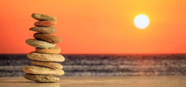 Дзен каміння стоїть на морському фоні під час заходу сонця
 - Фото, зображення