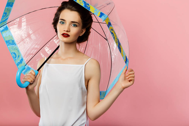 young cute woman with retro hair and umbrella - Foto, imagen
