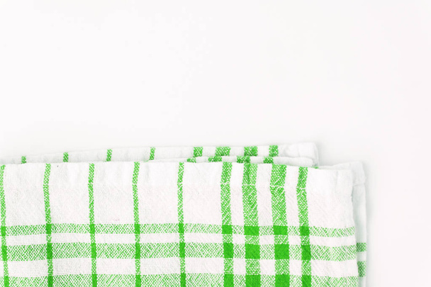 Pano verde, uma toalha de cozinha com um padrão xadrez, em um Whit
 - Foto, Imagem