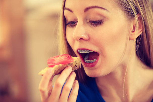 Woman having healthy breakfast eating sandwich - Фото, зображення