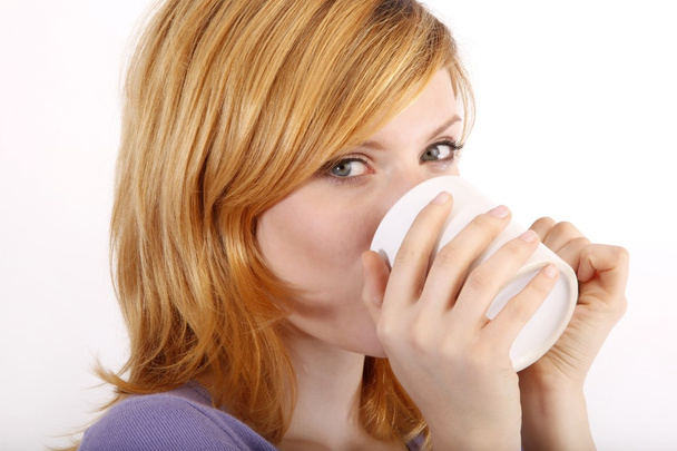 Girl drinking from a cup - Photo, image