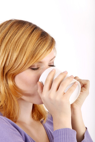 Girl drinking from a cup - Photo, image