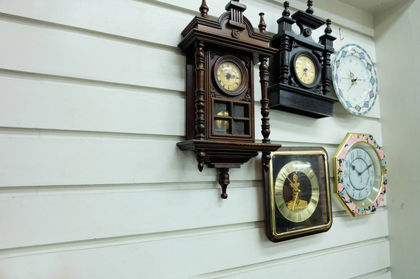 Vintage Clocks, Different Styles Old Clocks on Vintage Wall Background Background - 写真・画像
