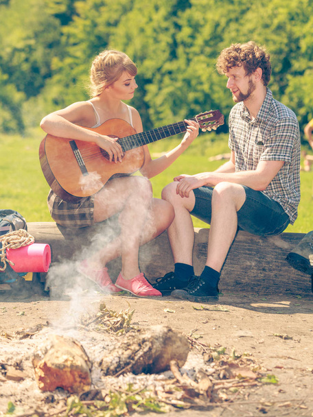 Young couple camping playing guitar outdoor - Fotoğraf, Görsel