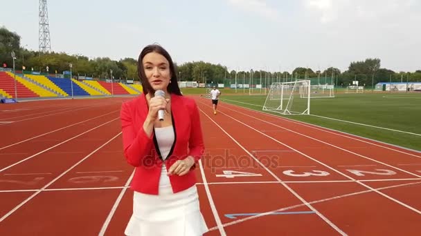 Young girl TV reporter is broadcasting - Filmati, video