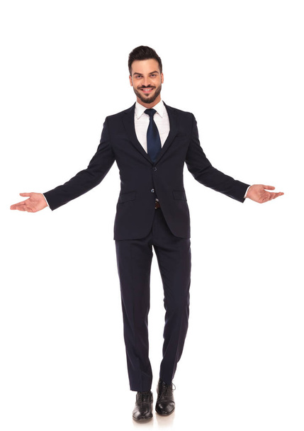 happy smiling young business man welcoming you  - Фото, изображение