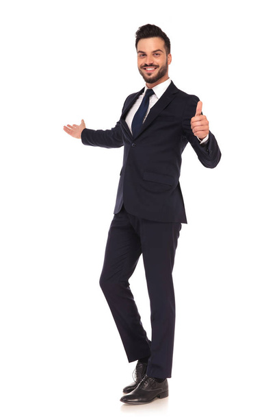 young business man presenting and making the ok hand sign  - Foto, imagen