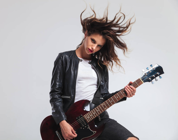 cool headbanging rock and roll woman playing electric guitar  - Photo, Image