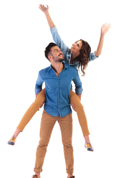 young casual couple celebrating success and looking up - Photo, Image