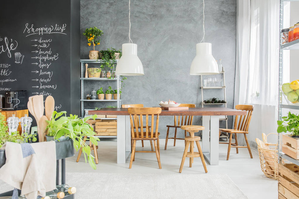Dining room with chalkboard wall - 写真・画像