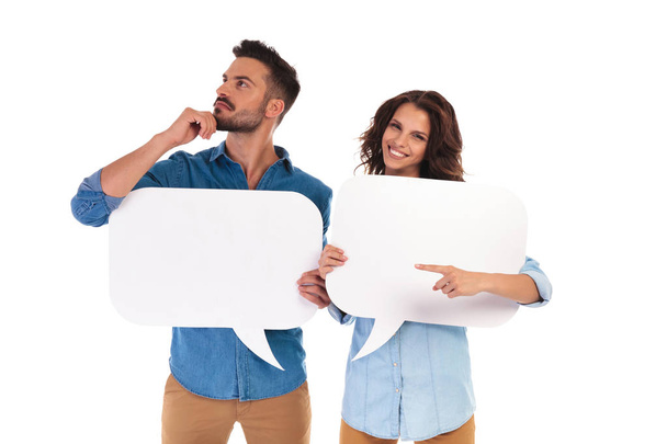 man is thinking while holding speech bubble near woman pointing  - Foto, immagini