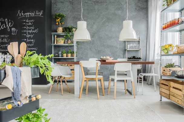 Industrial table and chalkboard wall - Foto, afbeelding