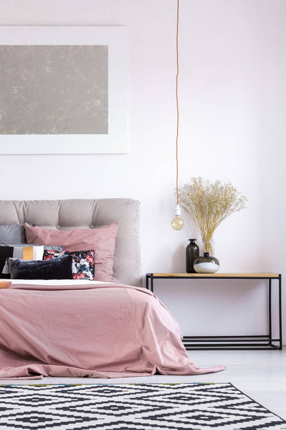 Pastel bedroom with copper lamp - 写真・画像
