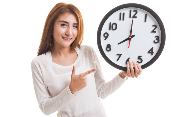 Young Asian woman point to a clock. - Foto, imagen