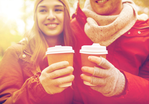 close up of happy couple with coffee in autumn - Foto, Imagem