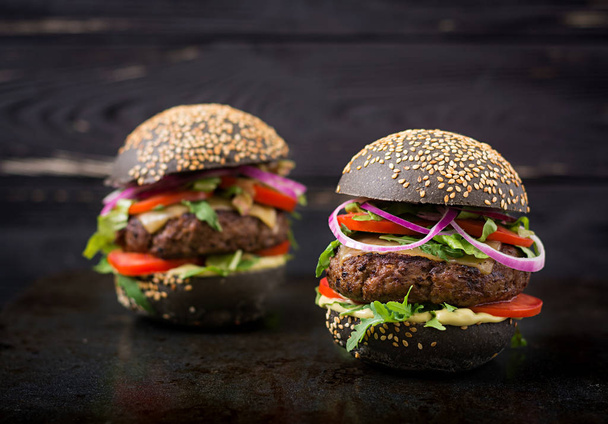 black hamburgers on black background - Φωτογραφία, εικόνα