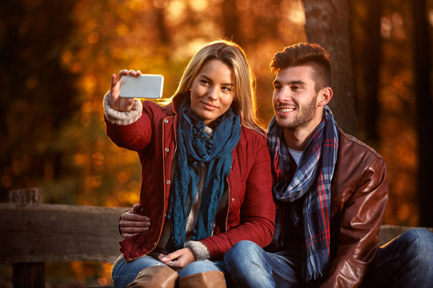 Lifestyle, happy couple in the park taking selfie - Photo, Image