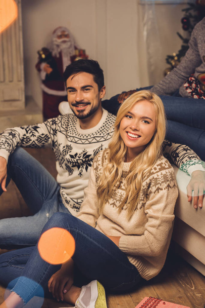 smiling couple on christmas eve - Фото, изображение