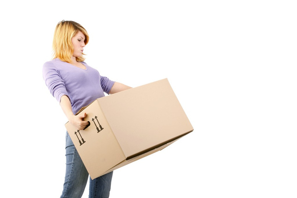 Young woman with moving boxes (white background) - Fotoğraf, Görsel