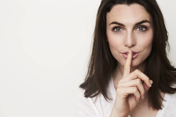 young attractive woman with finger to lips  - Foto, immagini
