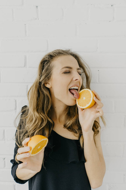 Young woman with orange halves - Photo, Image