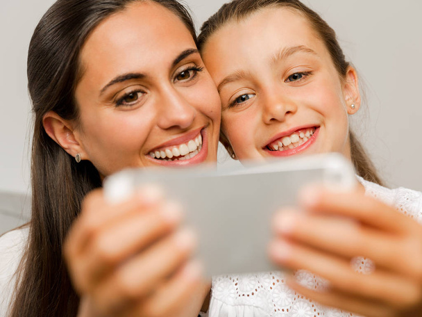 Mom and Daughter with smartphone - 写真・画像