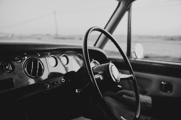 Classic and luxury car dashboard with steering wheel in main focus - Foto, Imagem