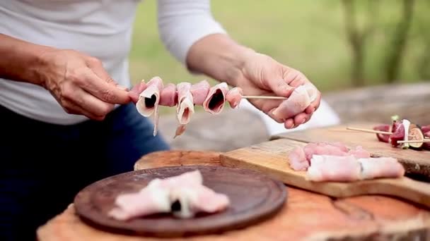 Assembling pork, prosciutto and prune kebabs - 映像、動画