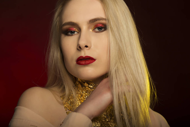 Fashion portrait of pretty blonde model with red lips and gold f - Photo, Image
