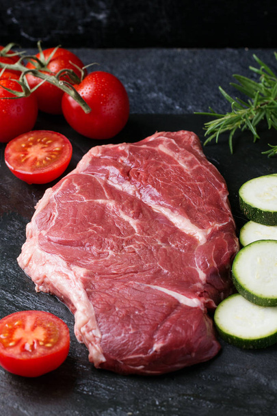 Raw steak with vegetables - Фото, изображение