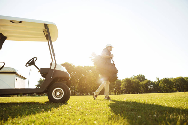 Male golfer walking with golf bag - Fotografie, Obrázek