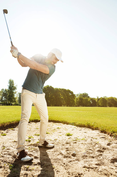 Golfer about to hit ball out of a sand bunker - Foto, Imagen