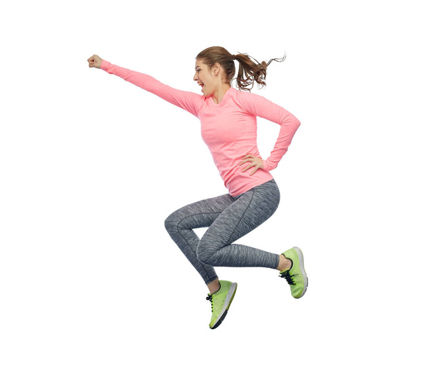 happy smiling sporty young woman jumping in air - Zdjęcie, obraz