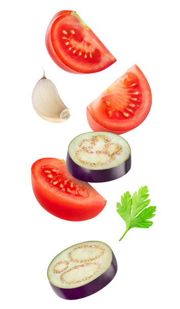 Falling slices of tomato and eggplant - Photo, Image