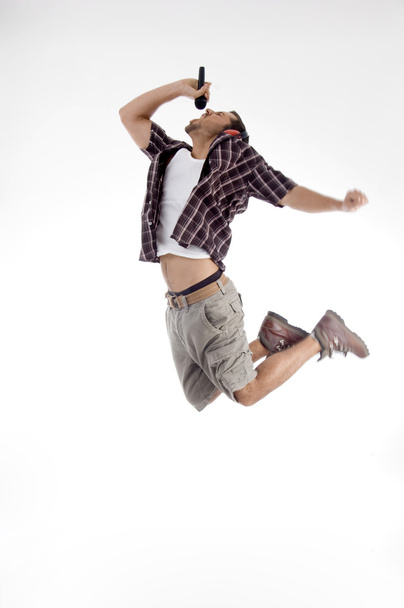 Young singer jumping high in air - Foto, immagini