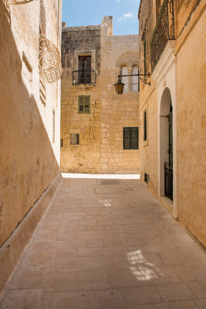 Narrow medieval street with stone houses in Mdina, Malta - Foto, Bild
