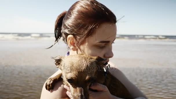 Girl playing with little doggy at seaside - Séquence, vidéo