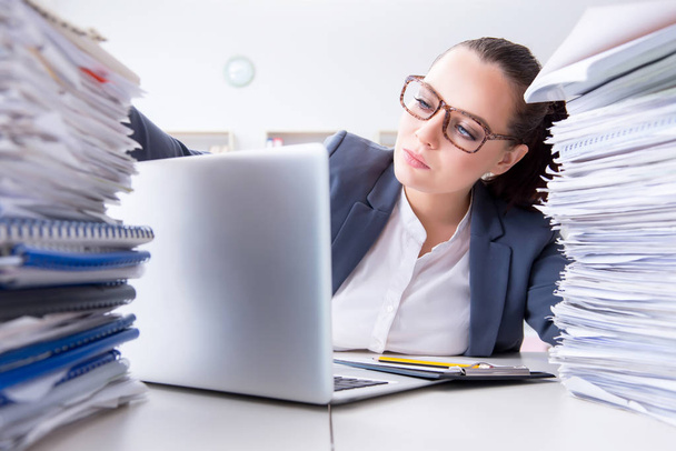 Tired businesswoman with paperwork workload - Fotoğraf, Görsel