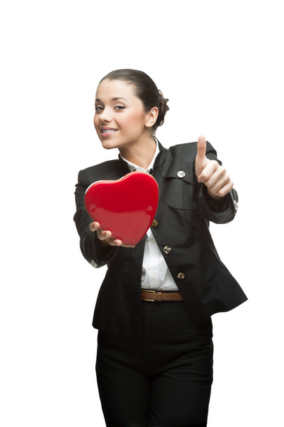 Smiling young business woman holding red heart - Photo, Image