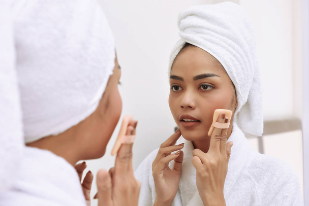 Young asian woman with bath towels cleanses her face  - Photo, image