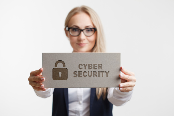 Business, Technology, Internet and network concept. Young girl holding a sign with an inscription cyber security - Photo, Image