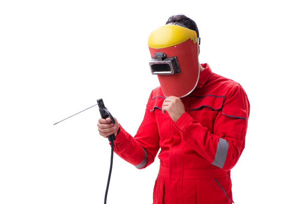 Young repairman with a welding gun electrode and a helmet isolat - Фото, изображение