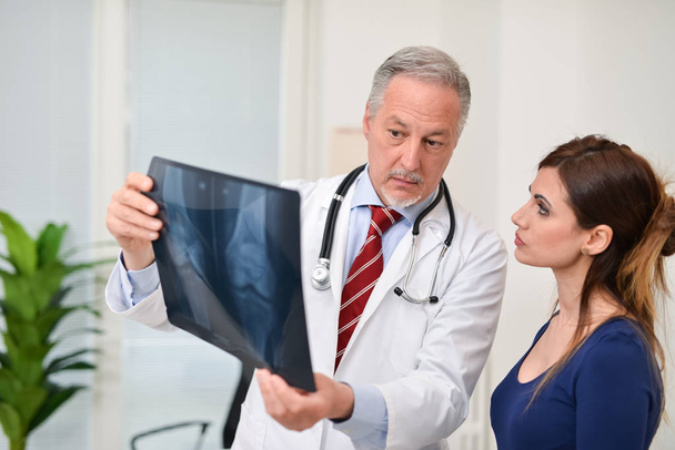 Doctor talking about radiography with patient - Photo, Image