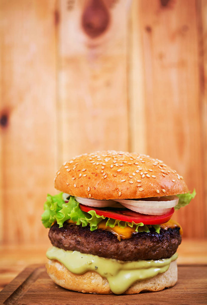 Delicious handmade burger on wooden background. Close view - Photo, Image